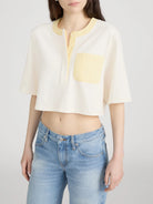 cropped cream top with yellow pocket