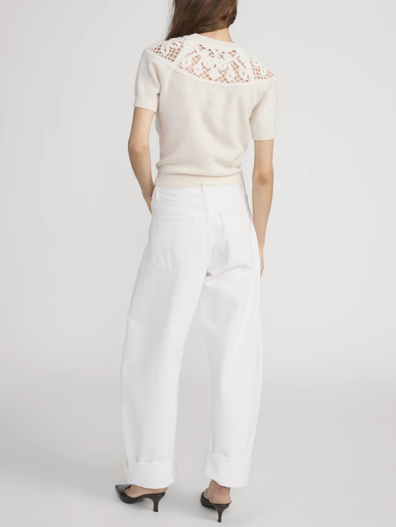 white denim pant with a bubble or curve leg