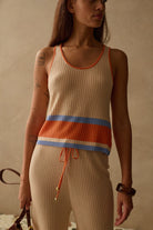cream knit tank top with orange and blue stripes on the bottom 