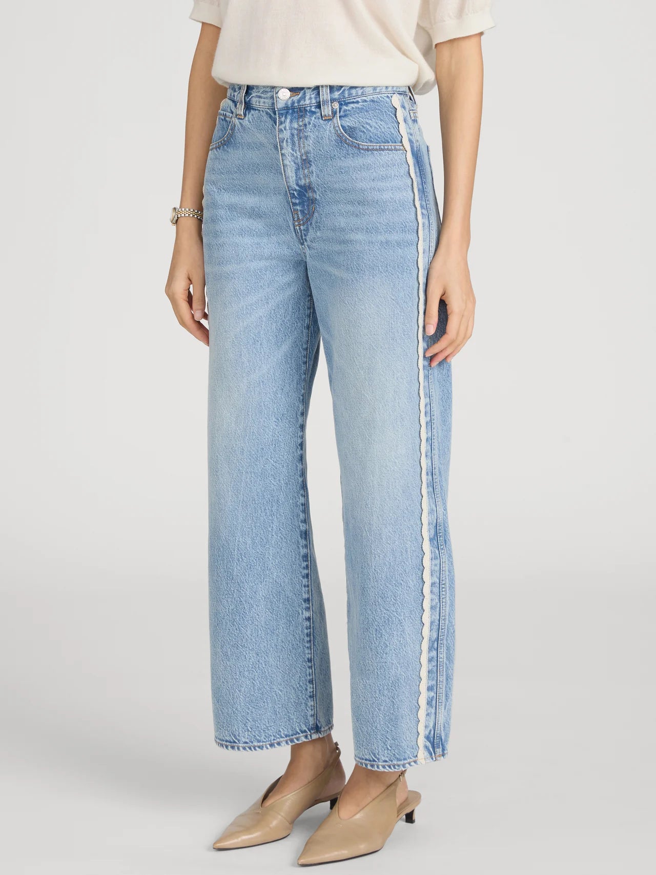 cropped light wash denim pant with a cream crochet detail on the sides 