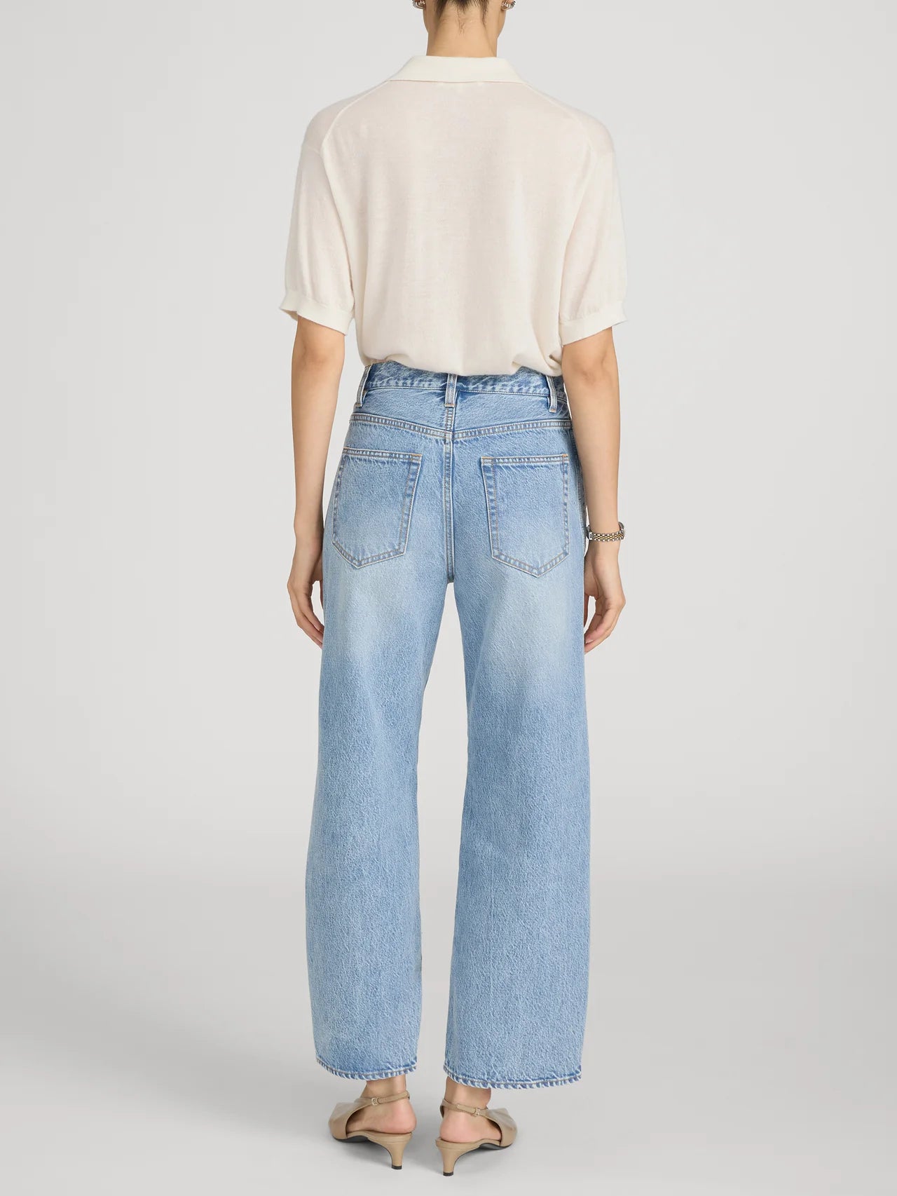 cropped light wash denim pant with a cream crochet detail on the sides 