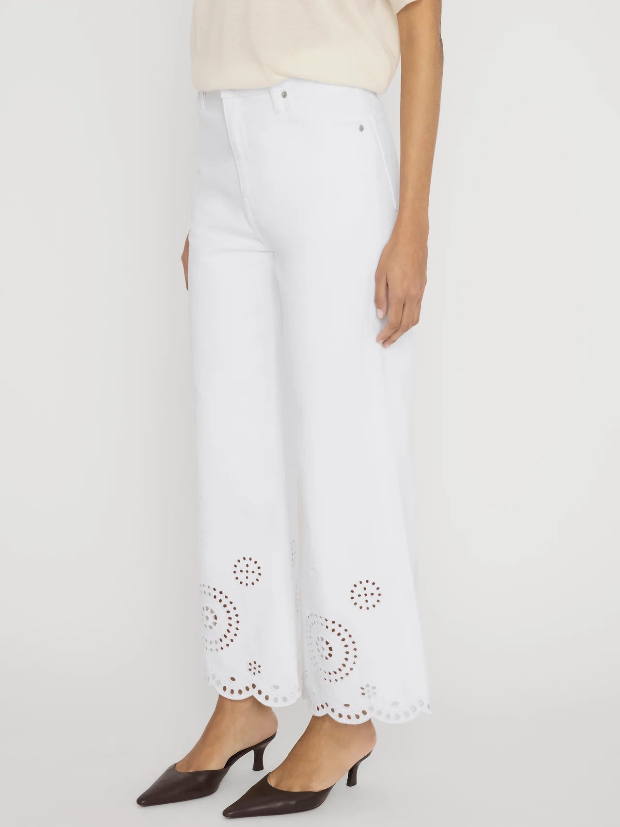 wide leg white denim pant with eyelet detail at the bottom