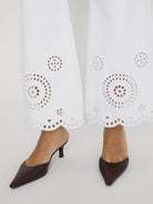 wide leg white denim pant with eyelet detail at the bottom