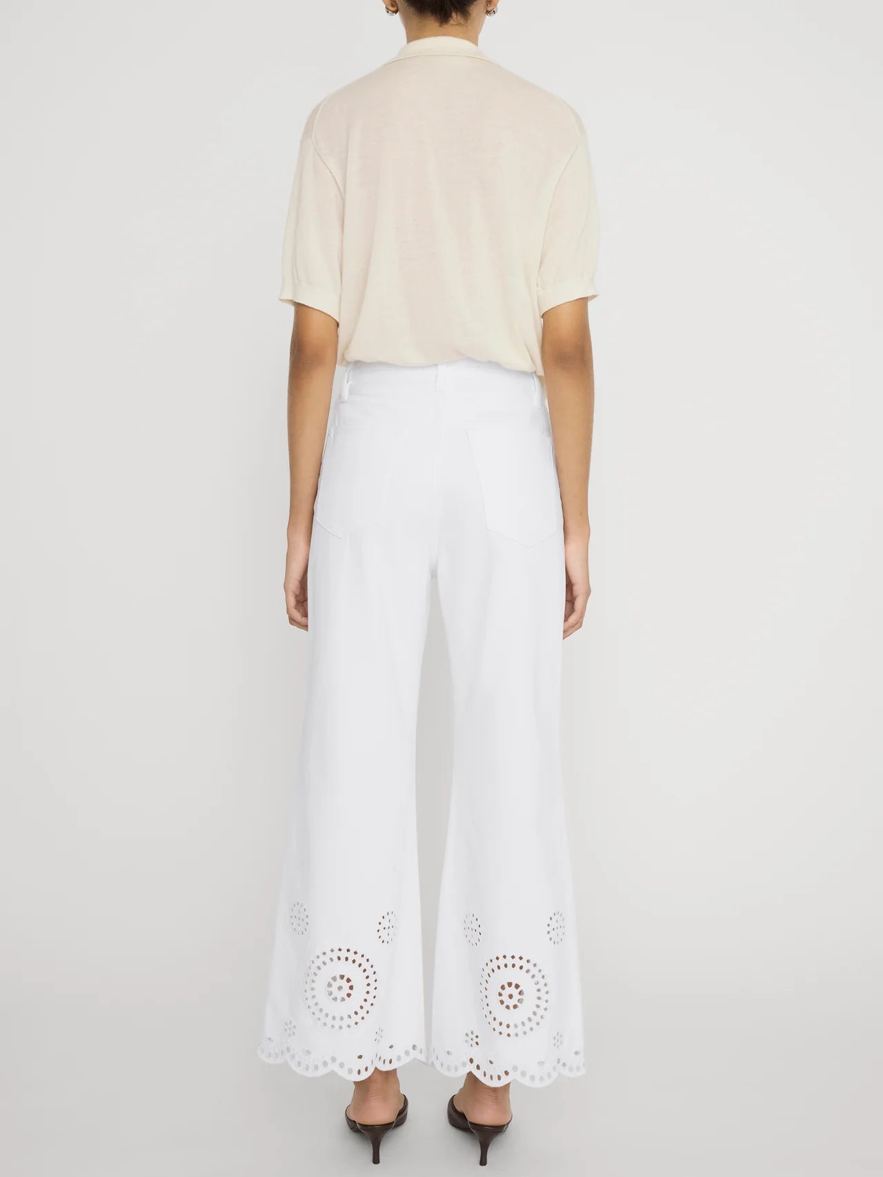 wide leg white denim pant with eyelet detail at the bottom