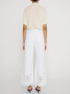 wide leg white denim pant with eyelet detail at the bottom