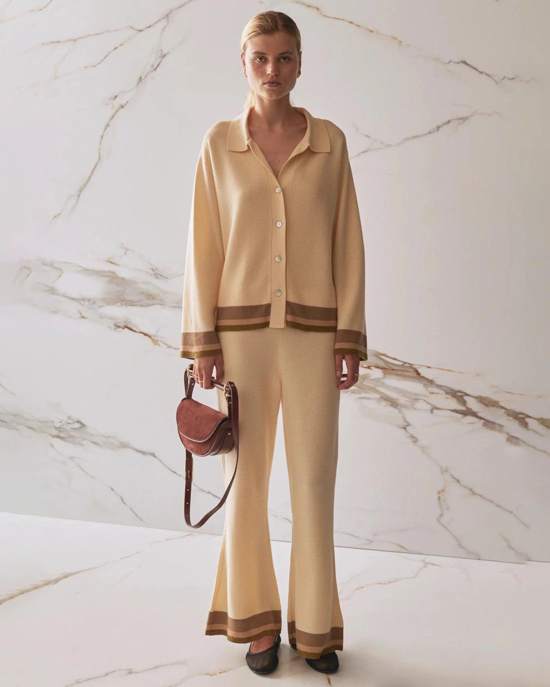 Woman wearing a beige  knit cardigan and matching trousers