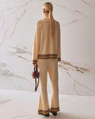 Woman wearing a beige  knit cardigan and matching trousers