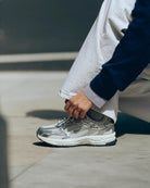 white running shoe with silvers accents
