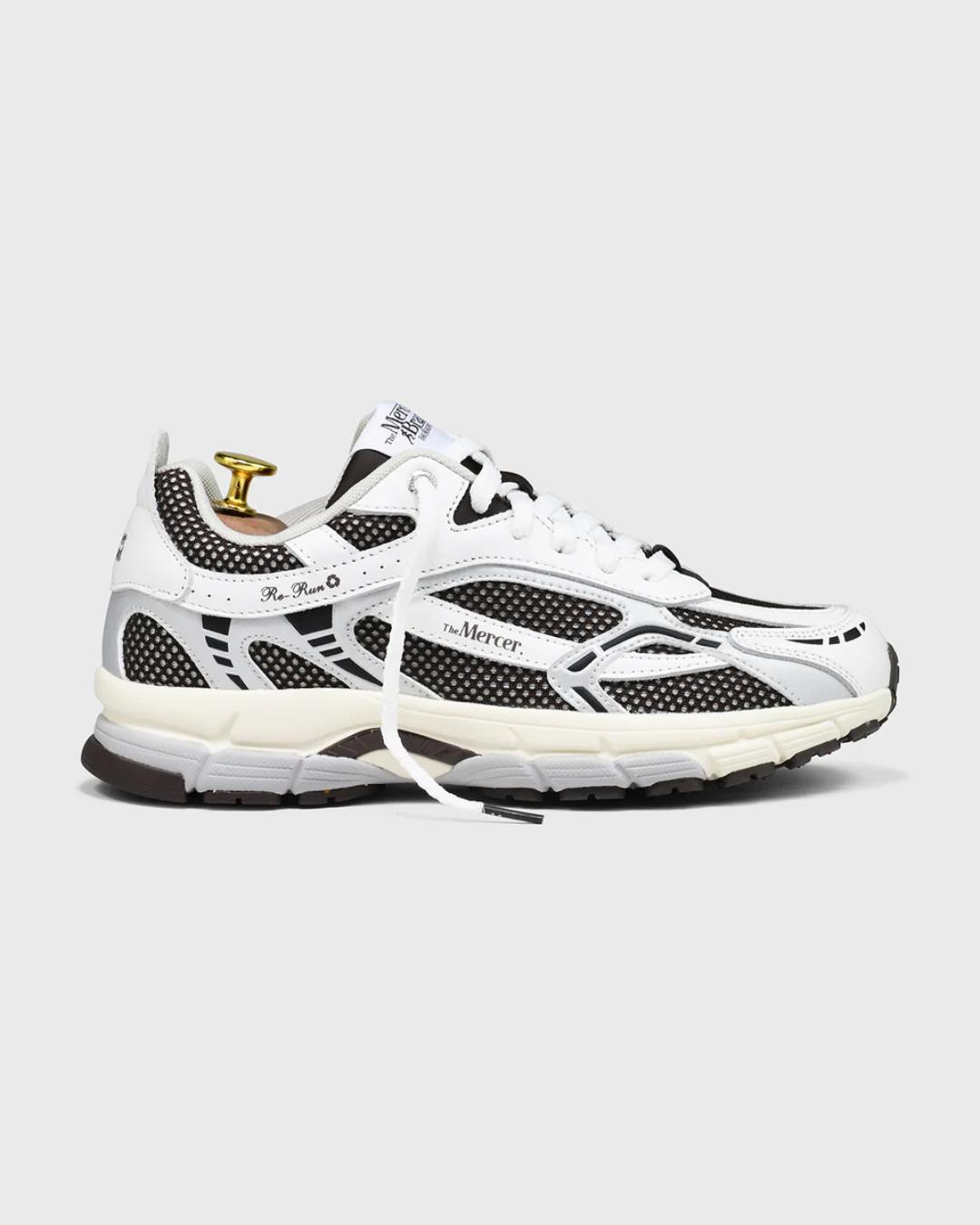 white and dark brown running shoe