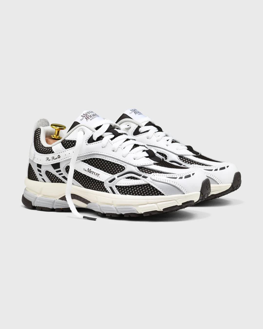 white and dark brown running shoe