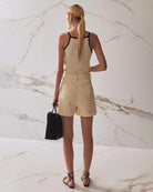 Person wearing beige high waisted denim shorts 