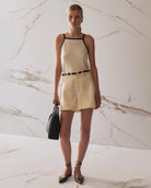 Person wearing beige high waisted denim shorts 