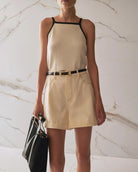 Person wearing beige high waisted denim shorts 