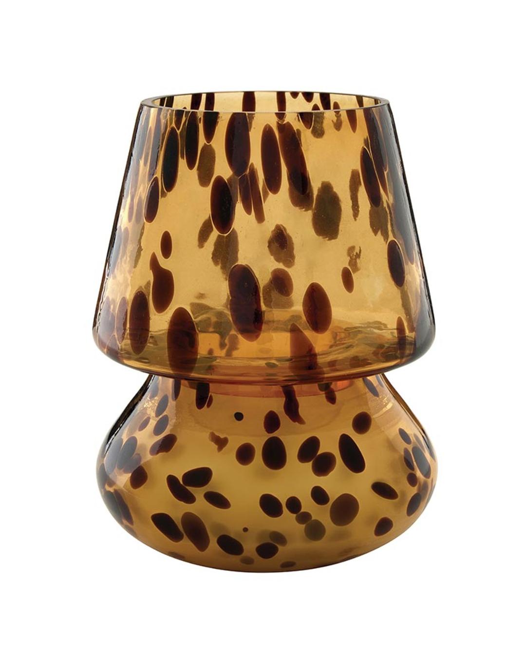 candle in a tortoise glass with a lid