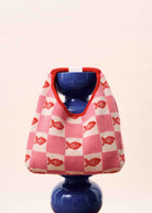 pink and white checkered hand bag with red fish on it