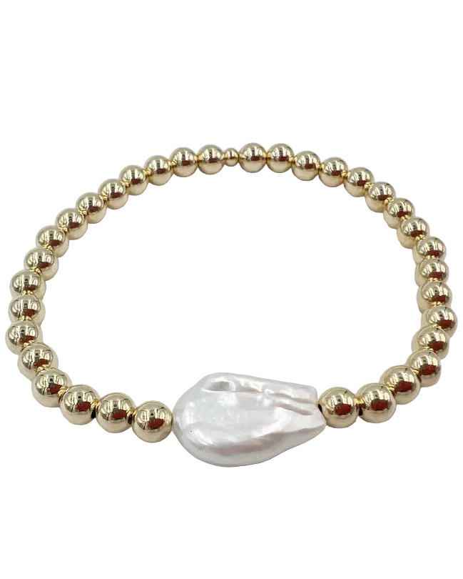 gold beaded bracelet with a large pearl in the middle