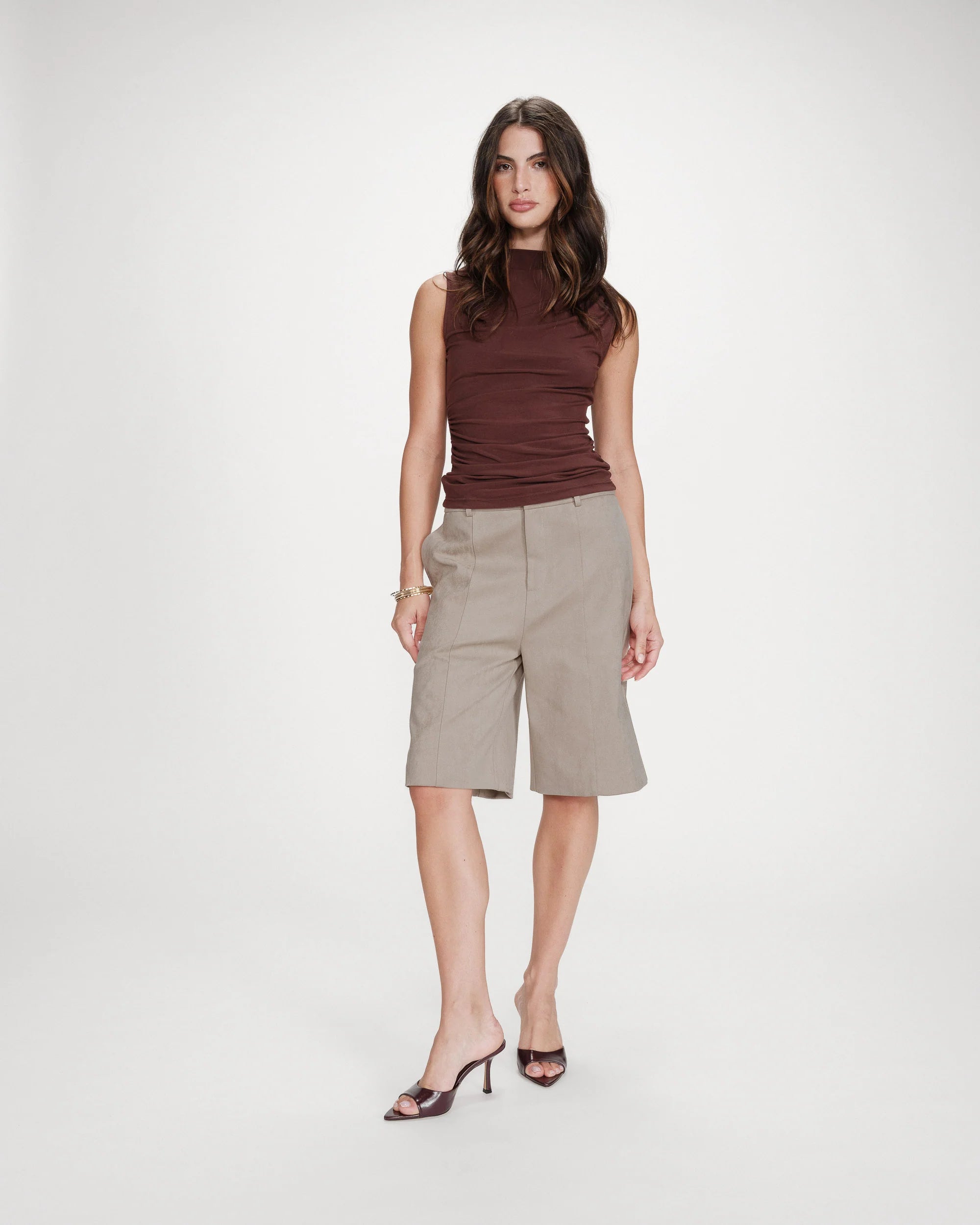 mock neck sleeveless top in brown with synching at the waist