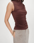 mock neck sleeveless top in brown with synching at the waist