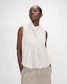 sleeveless top with bubble bottom and a tie at the neck in cream