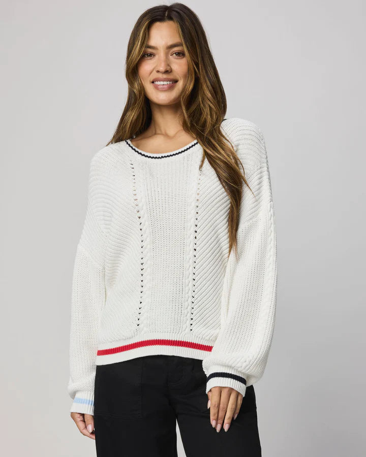 white sweater with navy at the collar and red at the bottom
