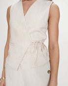 beige vest with a tie around the waist