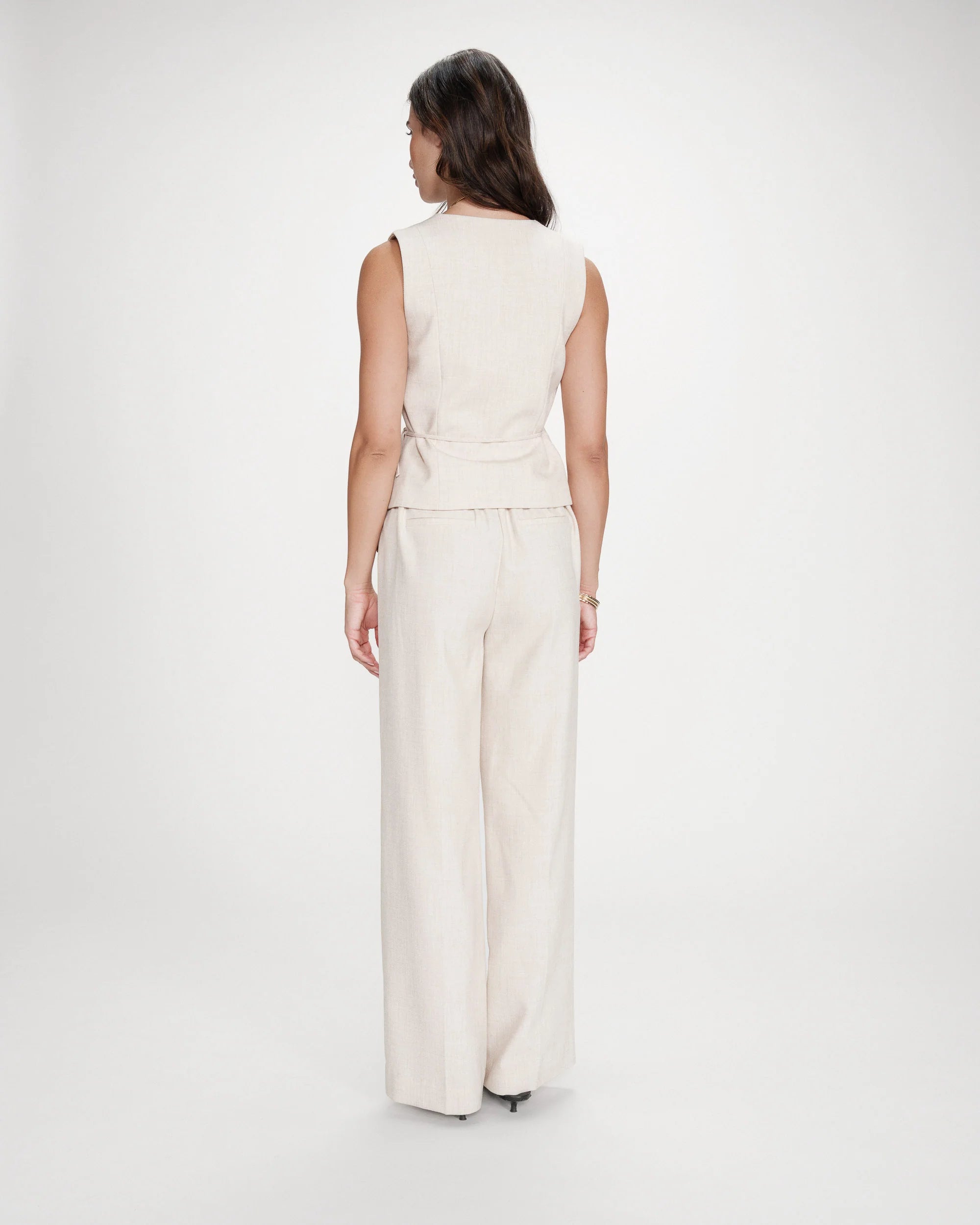 beige vest with a tie around the waist