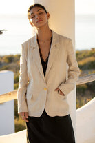 beige oversized blazer with a gold button