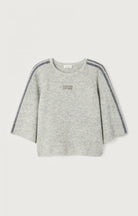 light grey sweater with dark grey striped down the sleeve