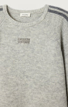 light grey sweater with dark grey striped down the sleeve