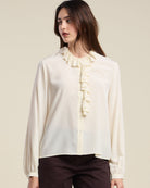 cream blouse with a ruffle collar