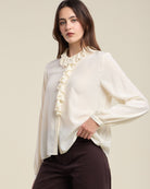 cream blouse with a ruffle collar