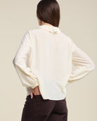 cream blouse with a ruffle collar