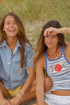 white beaded necklace with a red fish pendant
