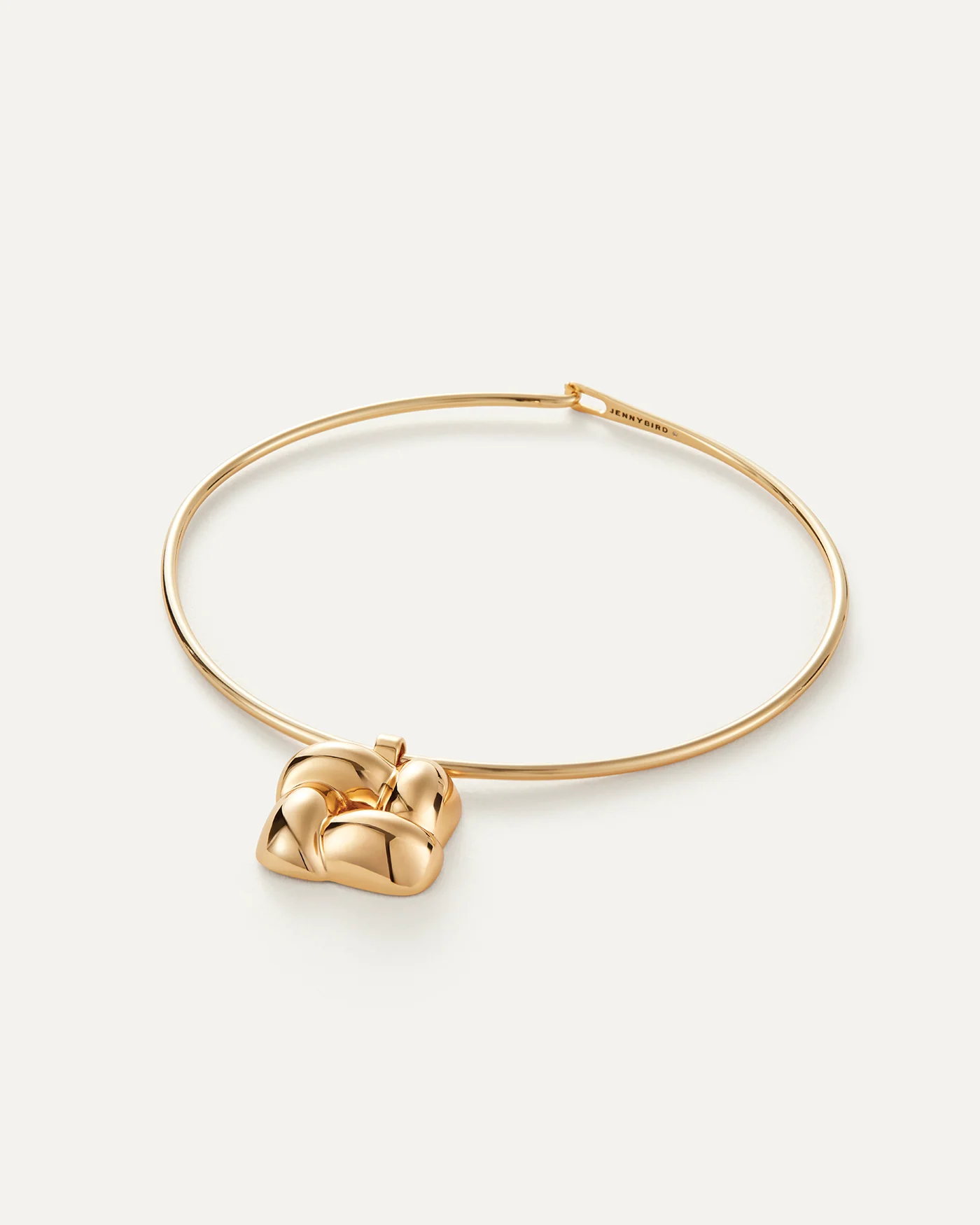 statement gold necklace with a woven pendant 