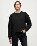 a woman wearing a cotton crew neck sweater in black