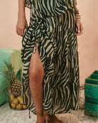 Woman in a zebra print dress in charcoal and cream